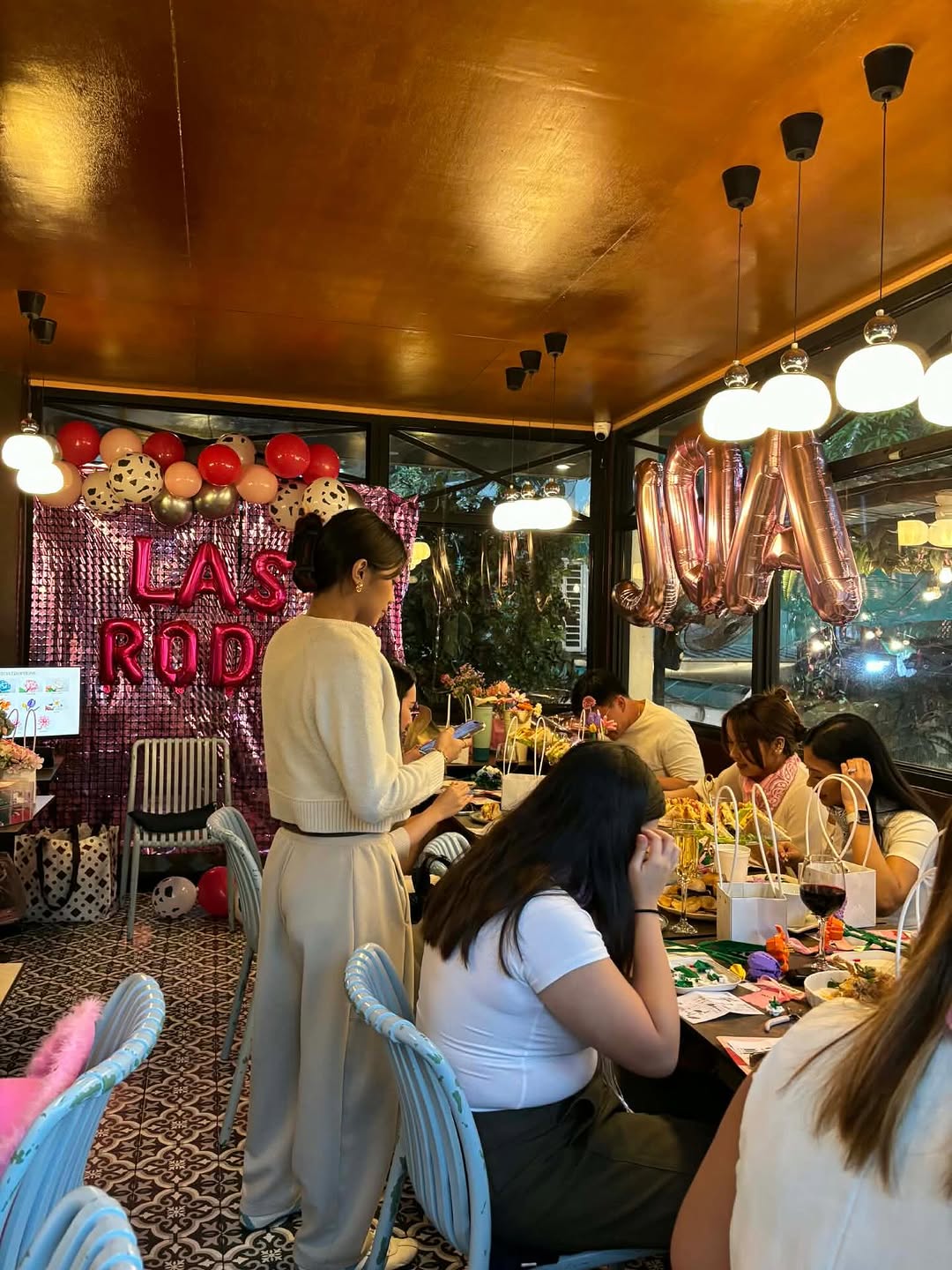 Event gathering at Flossom with custom backdrop and guests